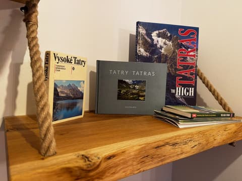 Tatra guidebooks, photo books and hiking maps on a rope-hung shelf