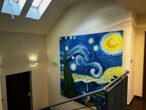 Top-floor landing under skylights with a large copy of Van Gogh's Starry Night