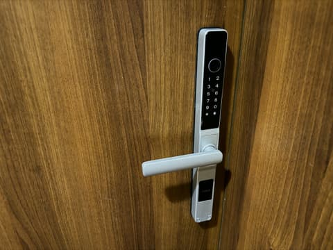 Keypad smart lock on the wooden apartment door